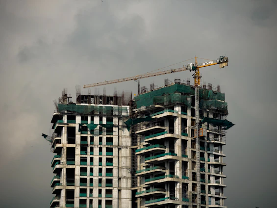 a tall building with a crane on top of it