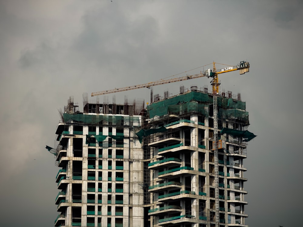 a tall building with a crane on top of it