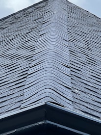 A close-up of high-quality roofing materials stacked neatly at a construction site.