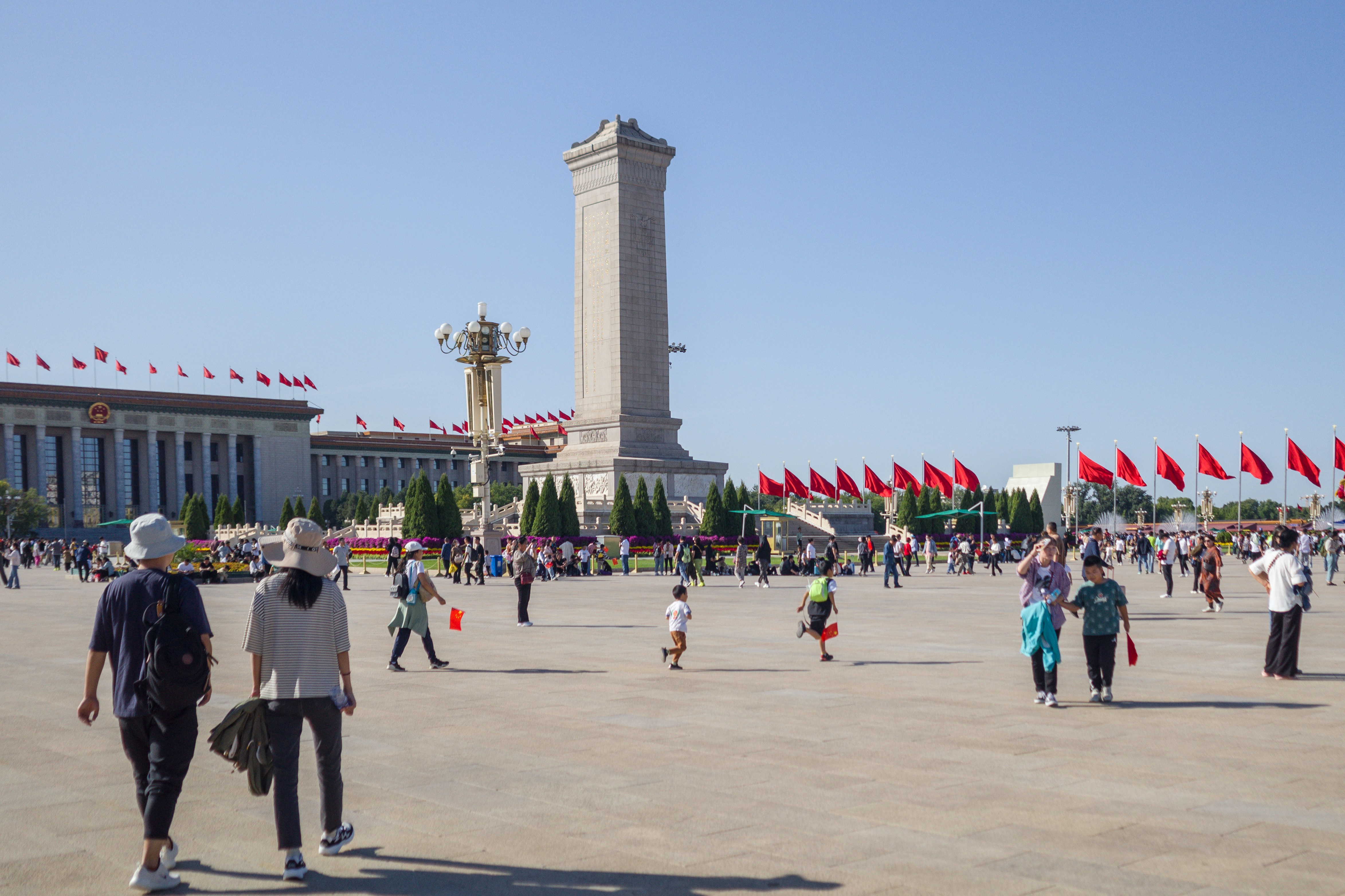 a group of people walking around a large building