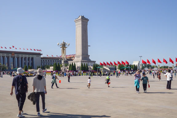 a group of people walking around a large building