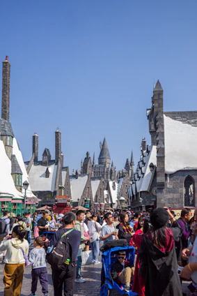 A vibrant medieval Minecraft village bustling with players crafting and exploring.