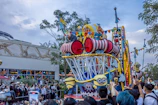 Colorful parade floats moving through the streets of Universal Orlando with excited visitors watching.
