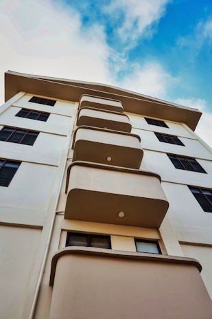 a tall white building with lots of windows