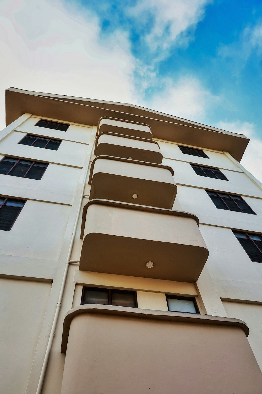 a tall white building with lots of windows