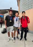 Team members posing with medals after an event.