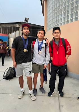 Team members posing with medals after an event.