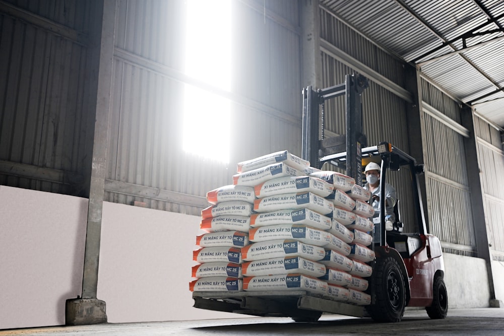 a forklift with a stack of boxes on top of it