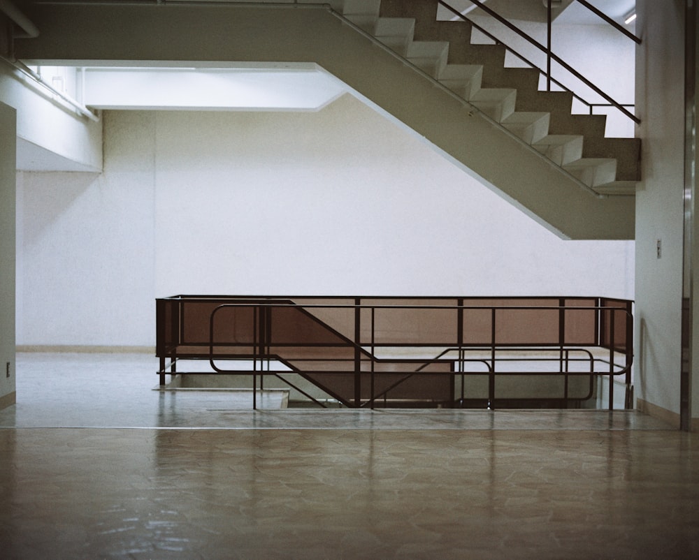 an empty room with a bench and stairs