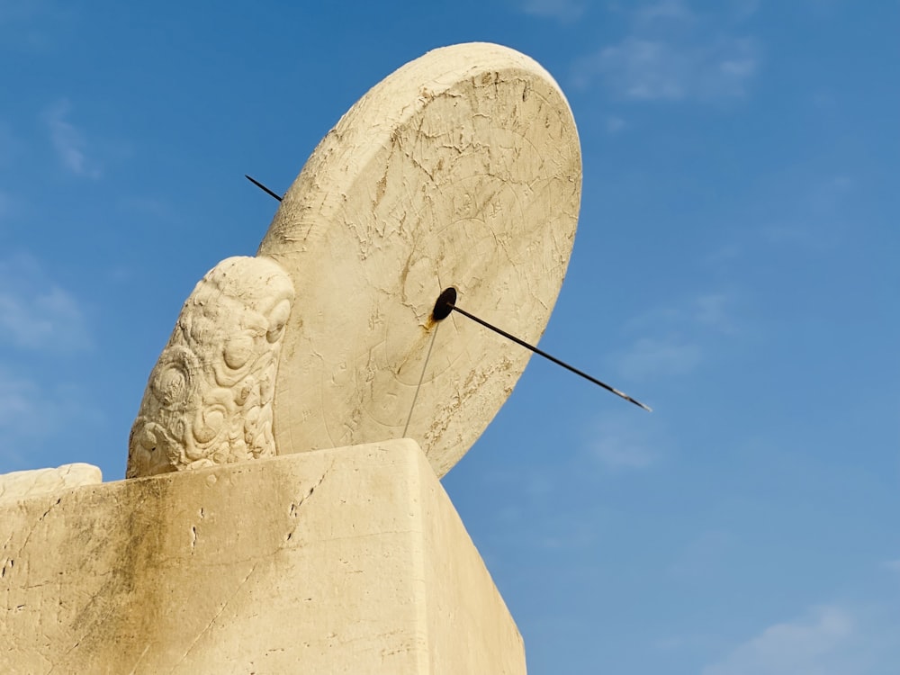 a sculpture of a head with a sword sticking out of it