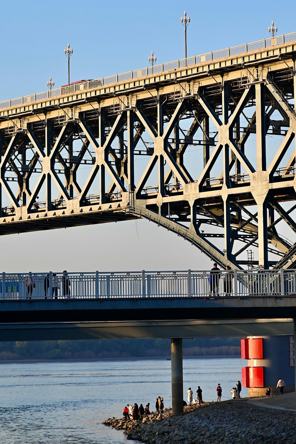 a bridge over a body of water with people walking on it