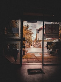 View from a hotel window overlooking a quiet, walkable neighborhood street.