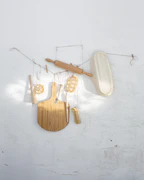 A collection of colorful kitchen gadgets and baking tools neatly arranged on a wooden countertop.
