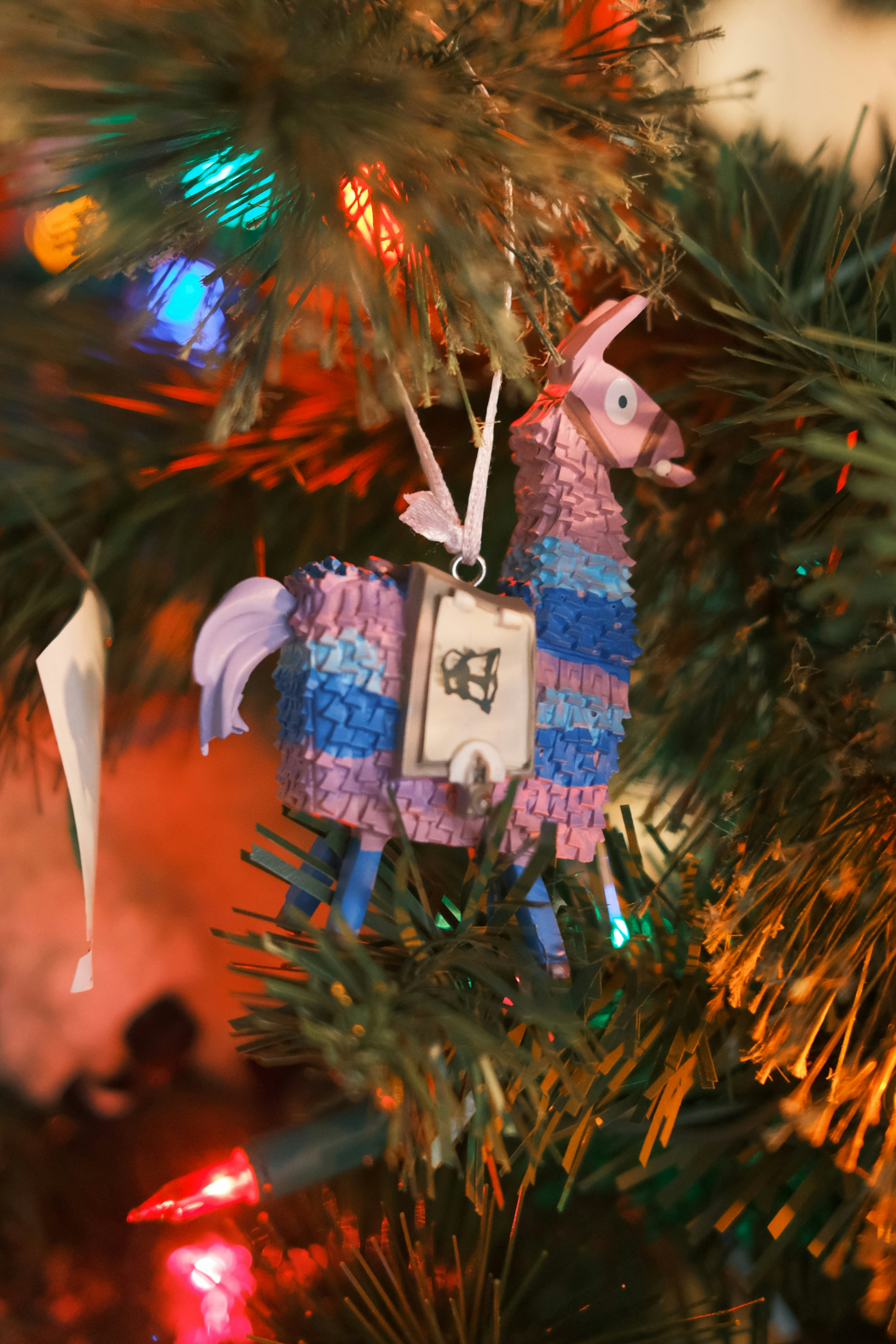 a colorful ornament hanging from a christmas tree