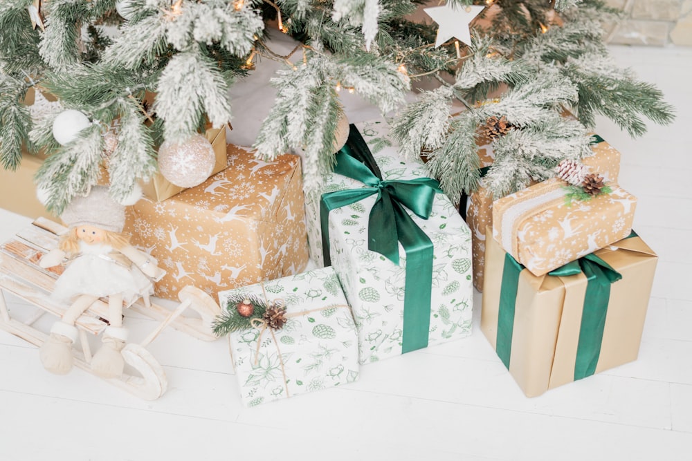 a group of wrapped presents under a christmas tree