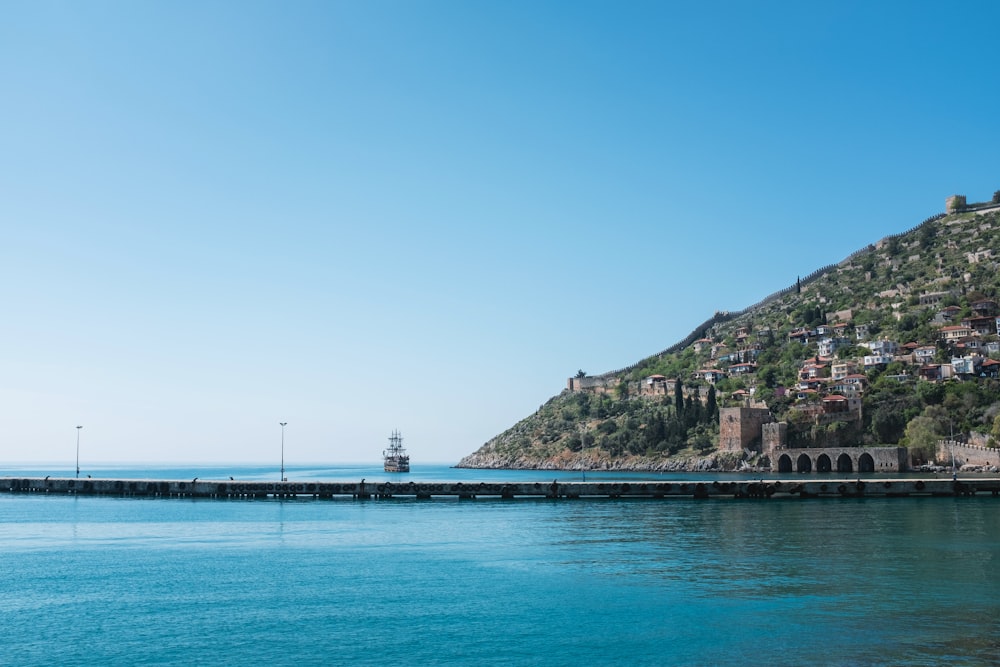 a large body of water with a hill in the background