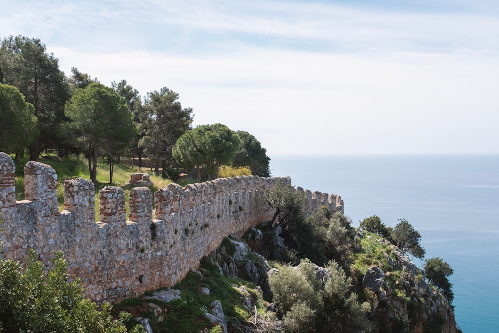 a stone wall on the side of a cliff