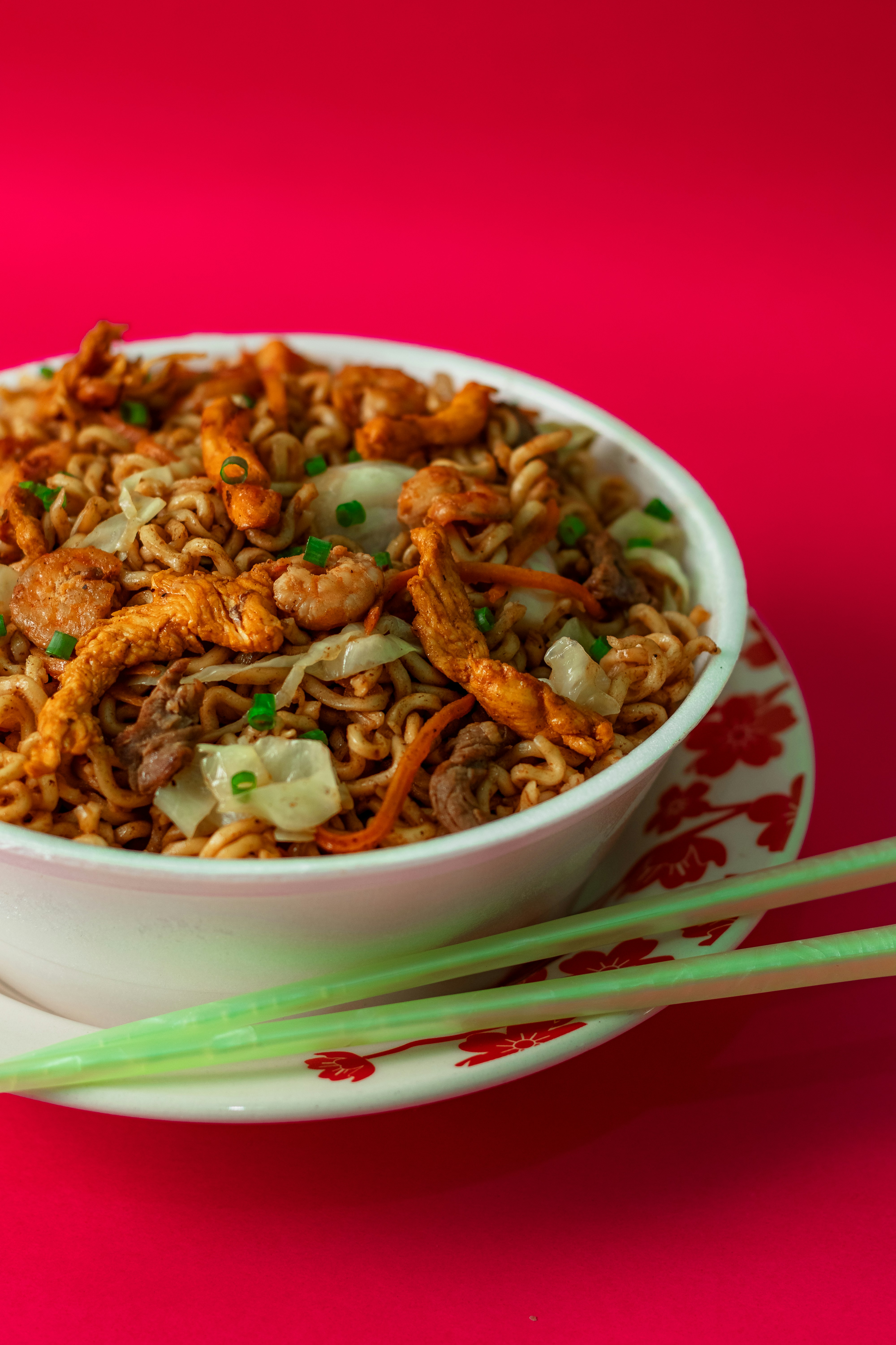 A savory bowl filled with stir-fried ground pork or chicken, shredded cabbage, carrots, and green onions, with a drizzle of soy sauce.