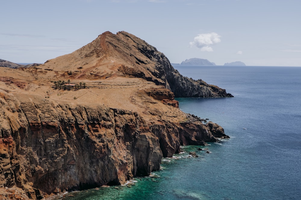 a rocky cliff overlooks a body of water