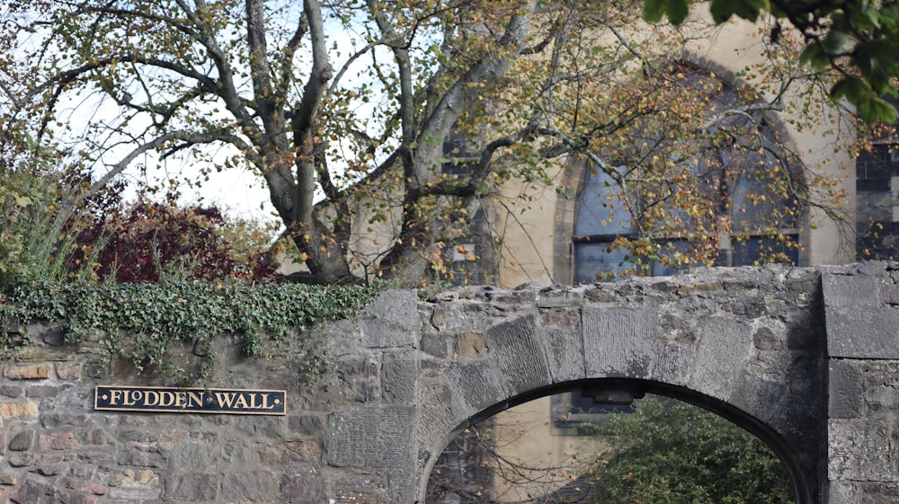 a stone bridge with a sign on it