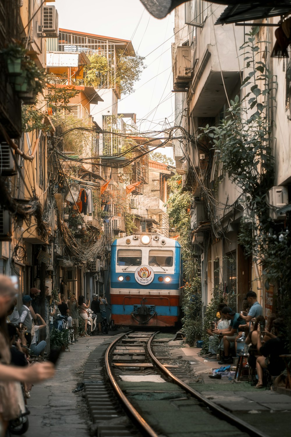 a blue and red train traveling down train tracks