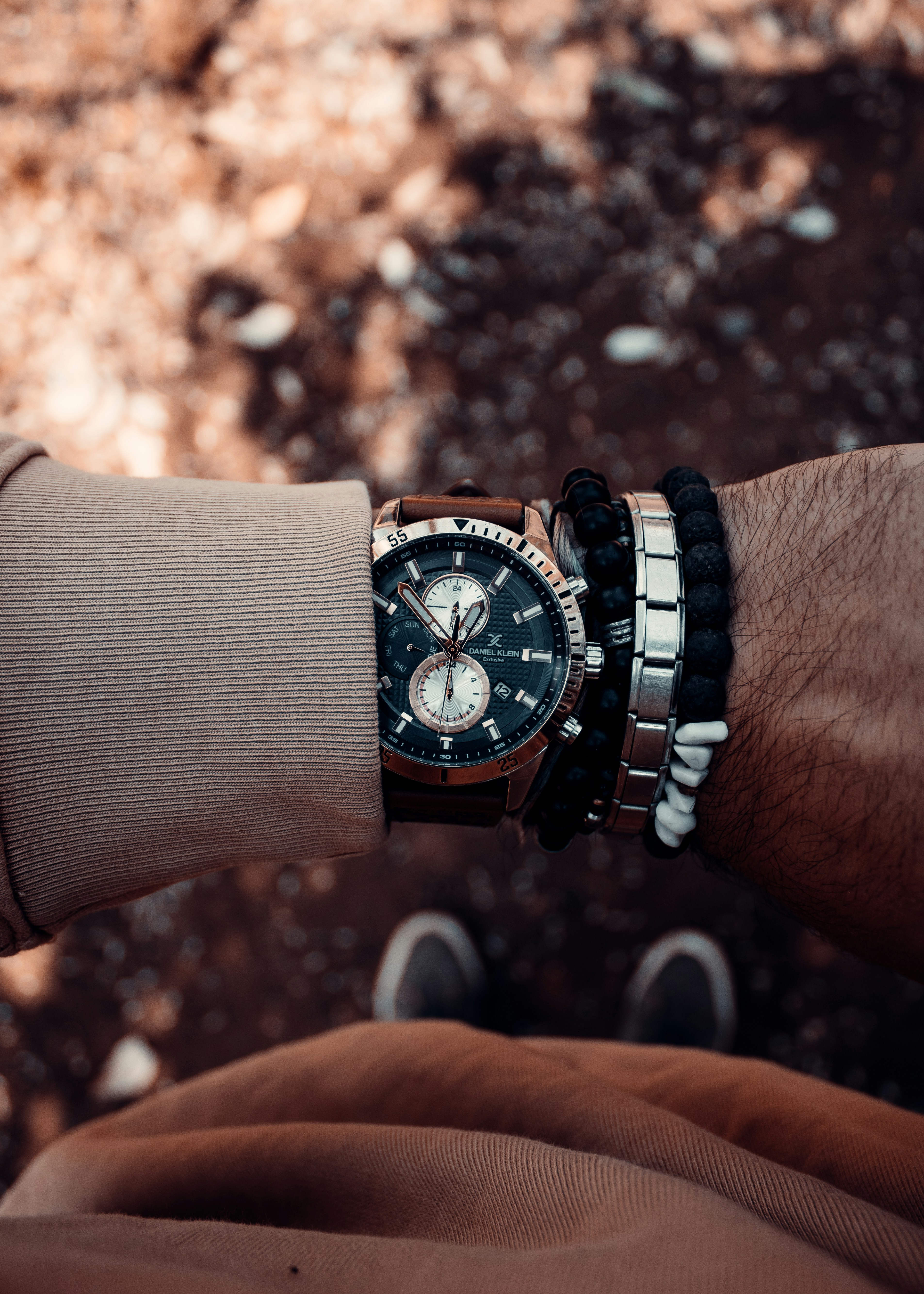 A man wearing a watch and bracelets on his wrist photo Free Daniel