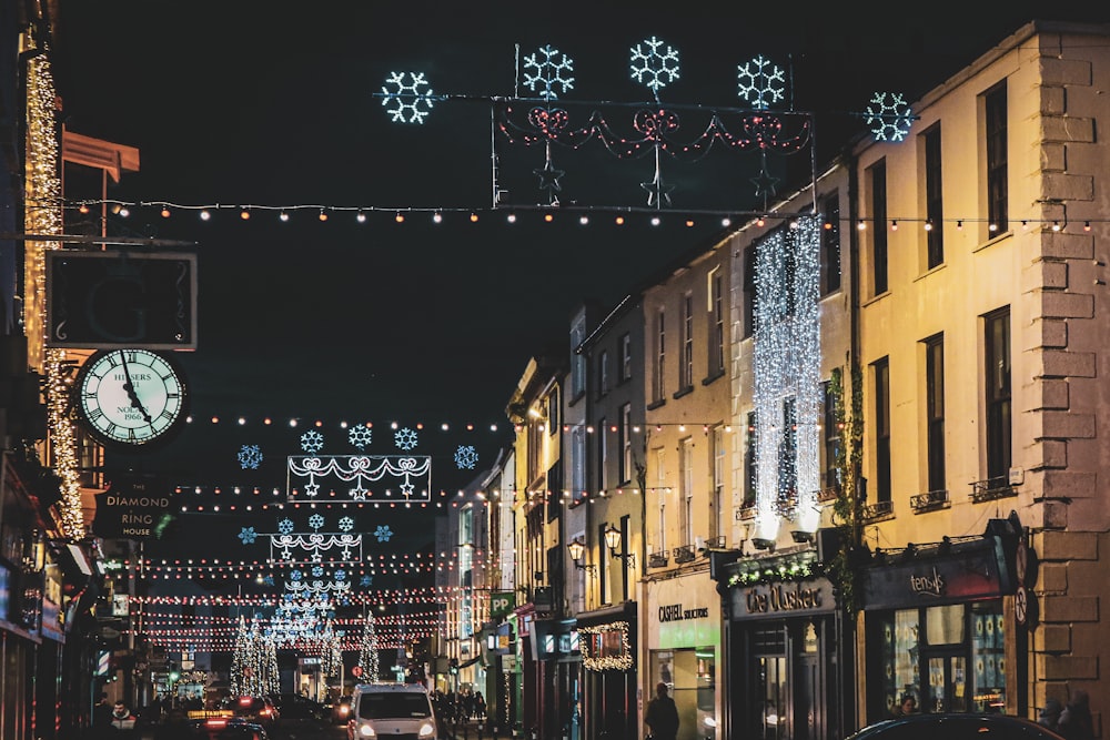 a city street is decorated with christmas lights and snowflakes