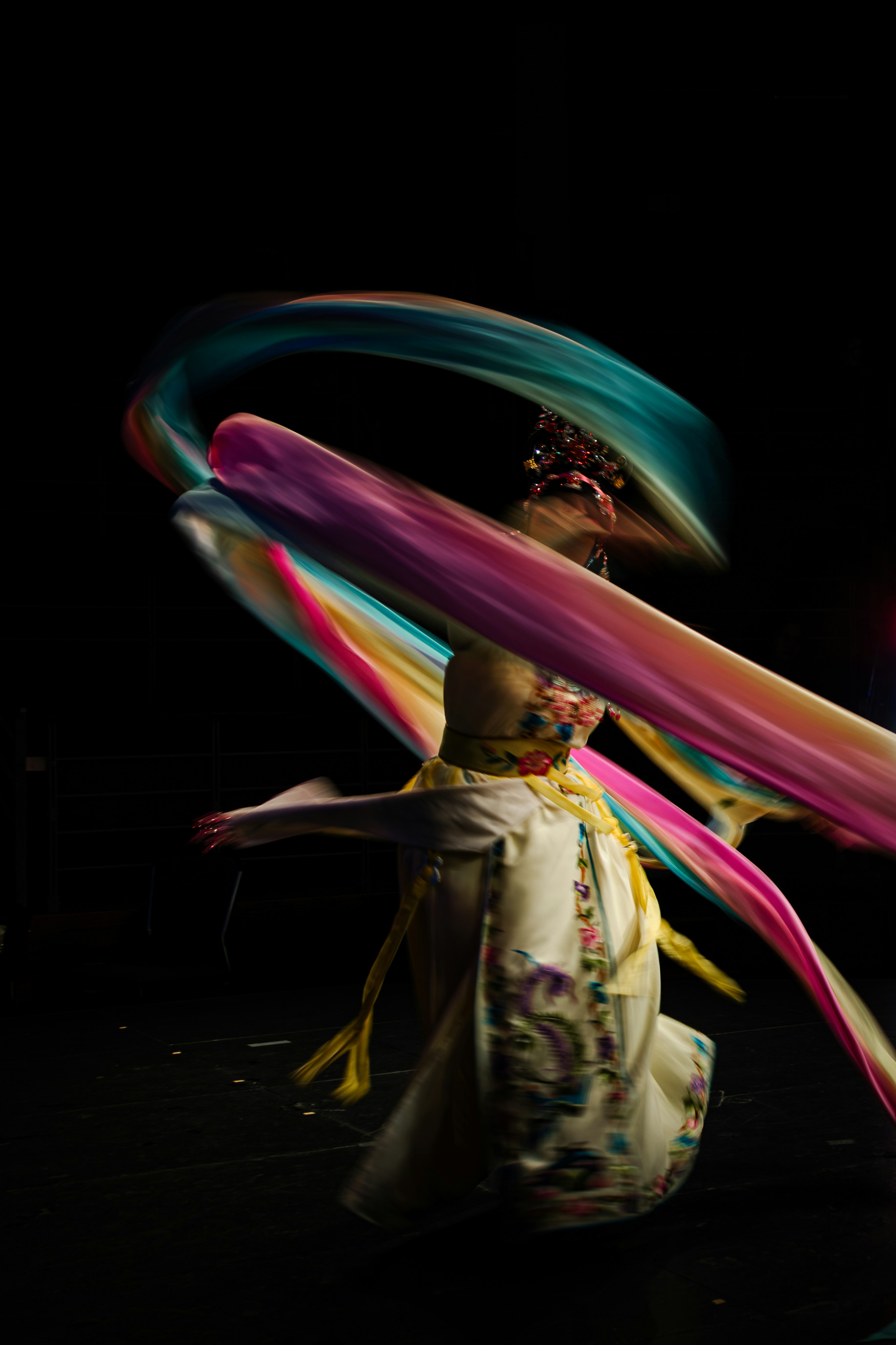 A woman is dancing with colorful streamers in her hair photo Free Chinese art Image on Unsplash