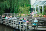 Guests enjoying a quiet moment on the resort’s wooden deck overlooking the river.