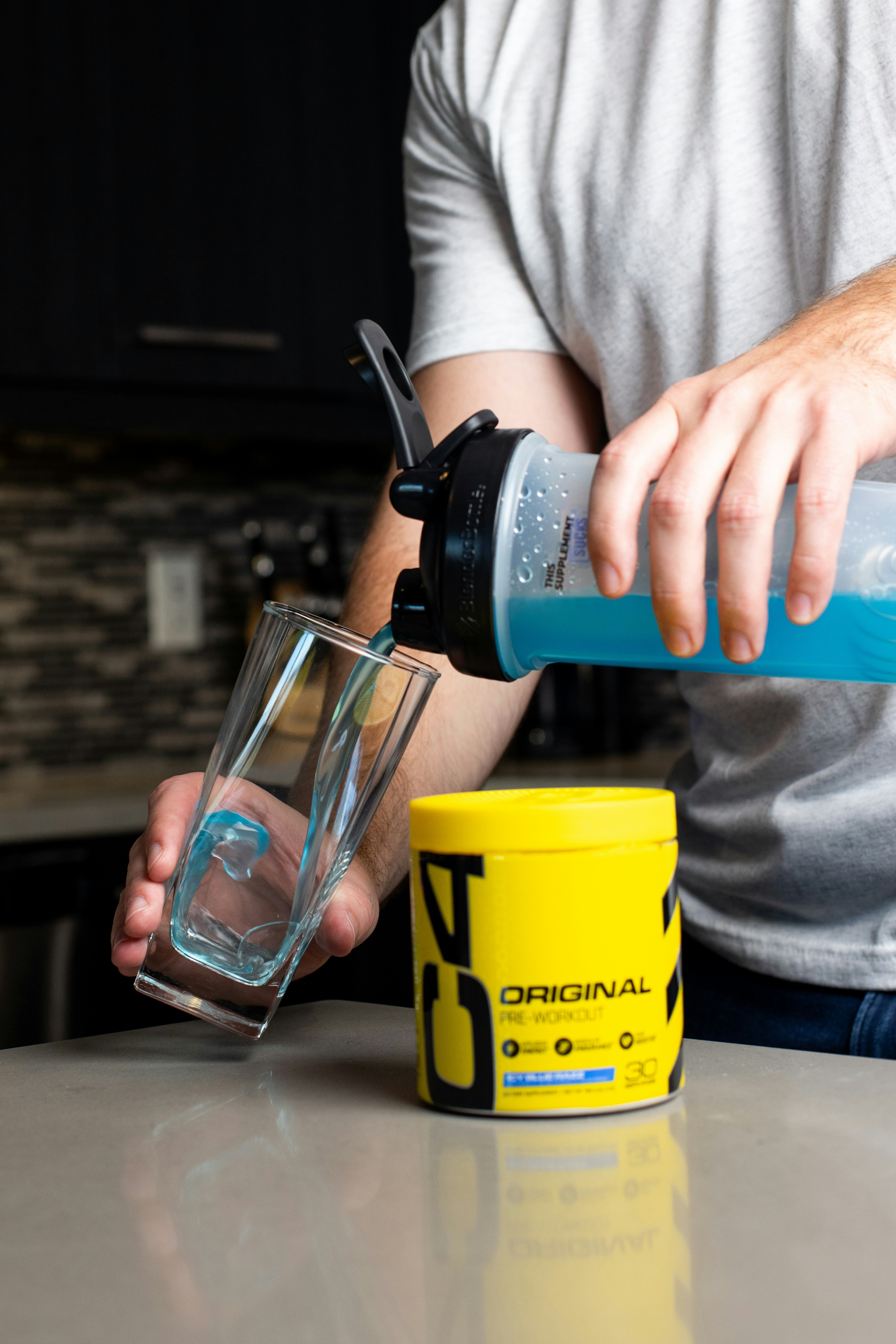 a man is pouring a drink into a glass