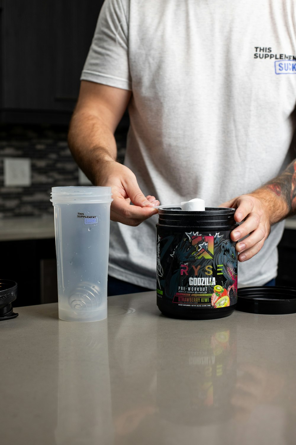 a man holding a container of food on a counter