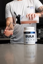 a man pouring a drink into a glass