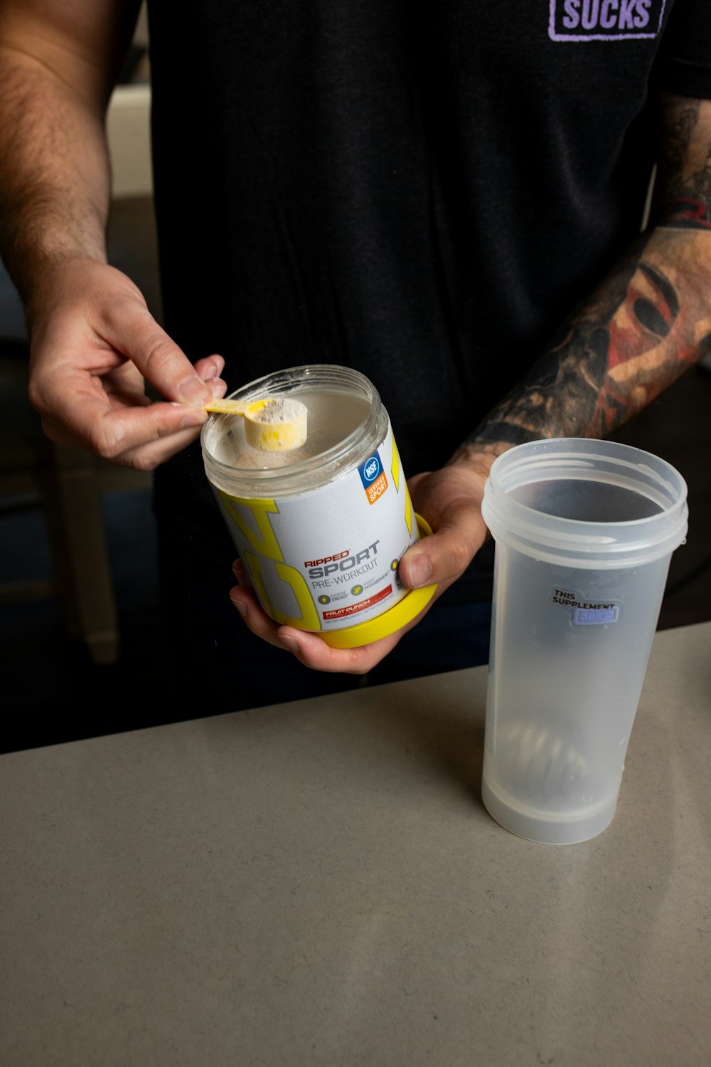 a man holding a can of ice cream and a cup of coffee