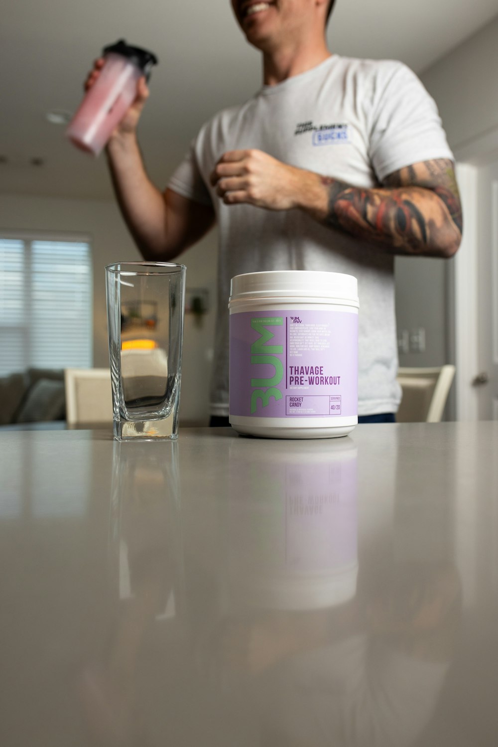 a man holding a cup and a jar of water