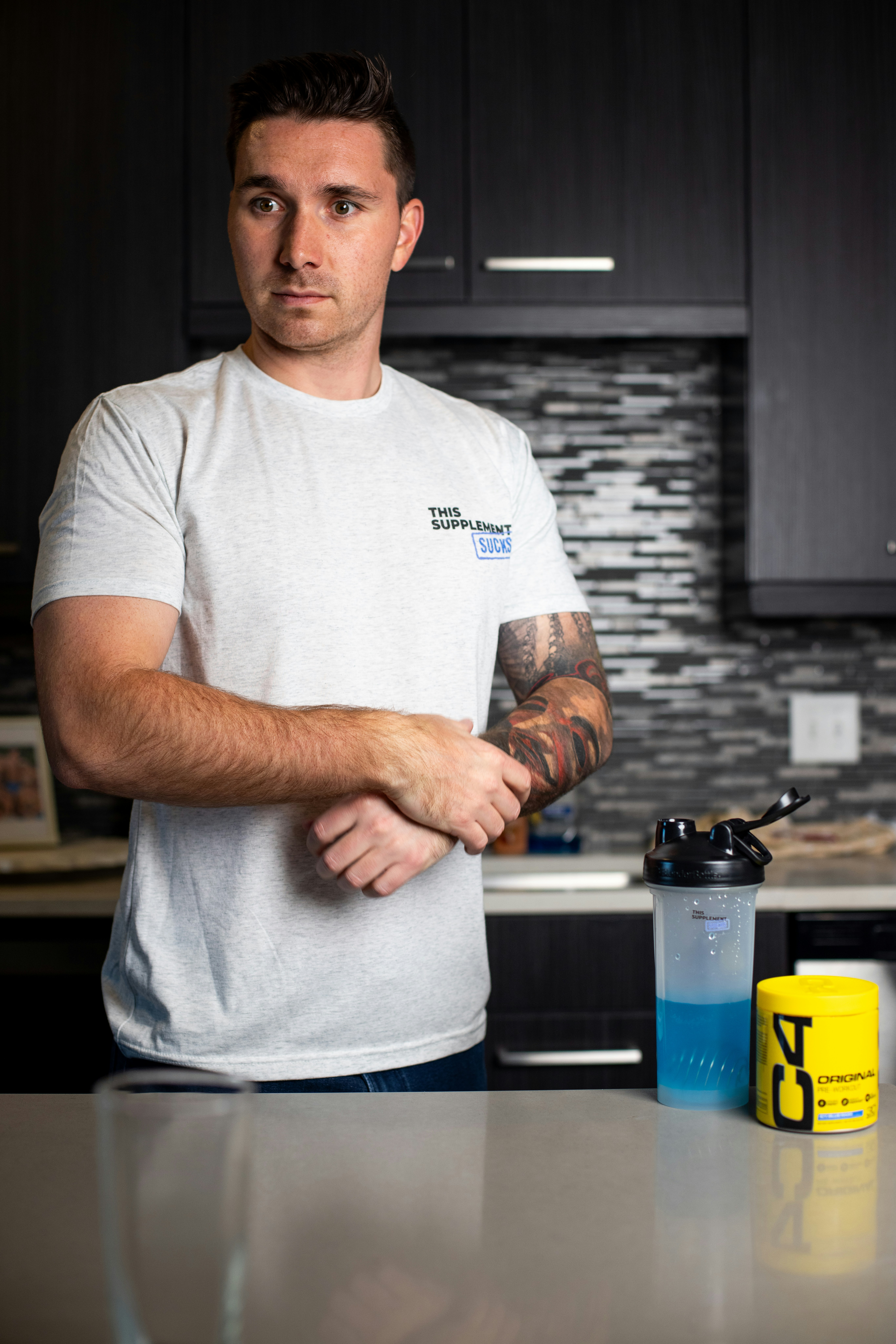 a man standing in a kitchen next to a counter