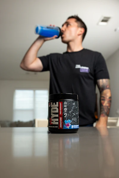 Focused athlete drinking an electrolyte hydration mix between rounds in training.