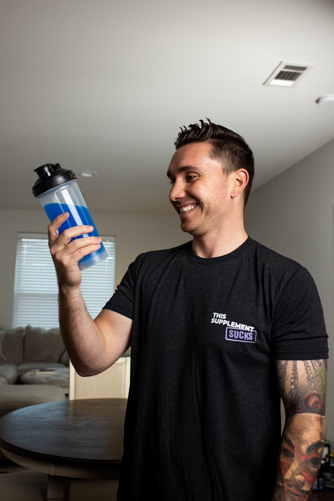 Fit active man holding a shaker bottle