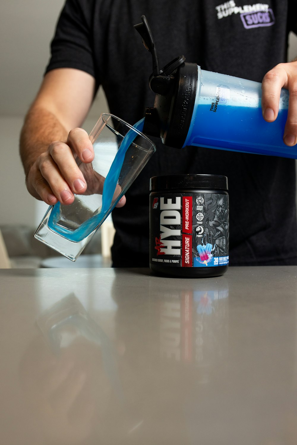 a man pouring a drink into a glass