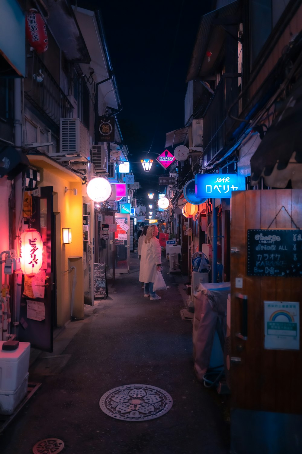 a couple of people that are walking down a street