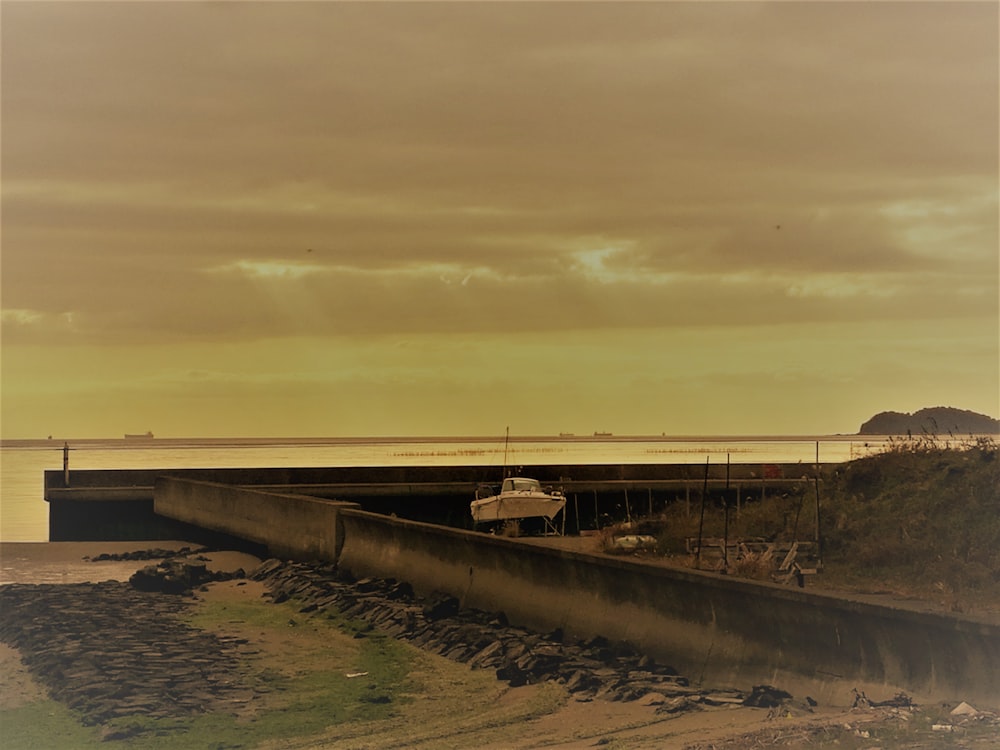 a boat sitting on the shore of a body of water