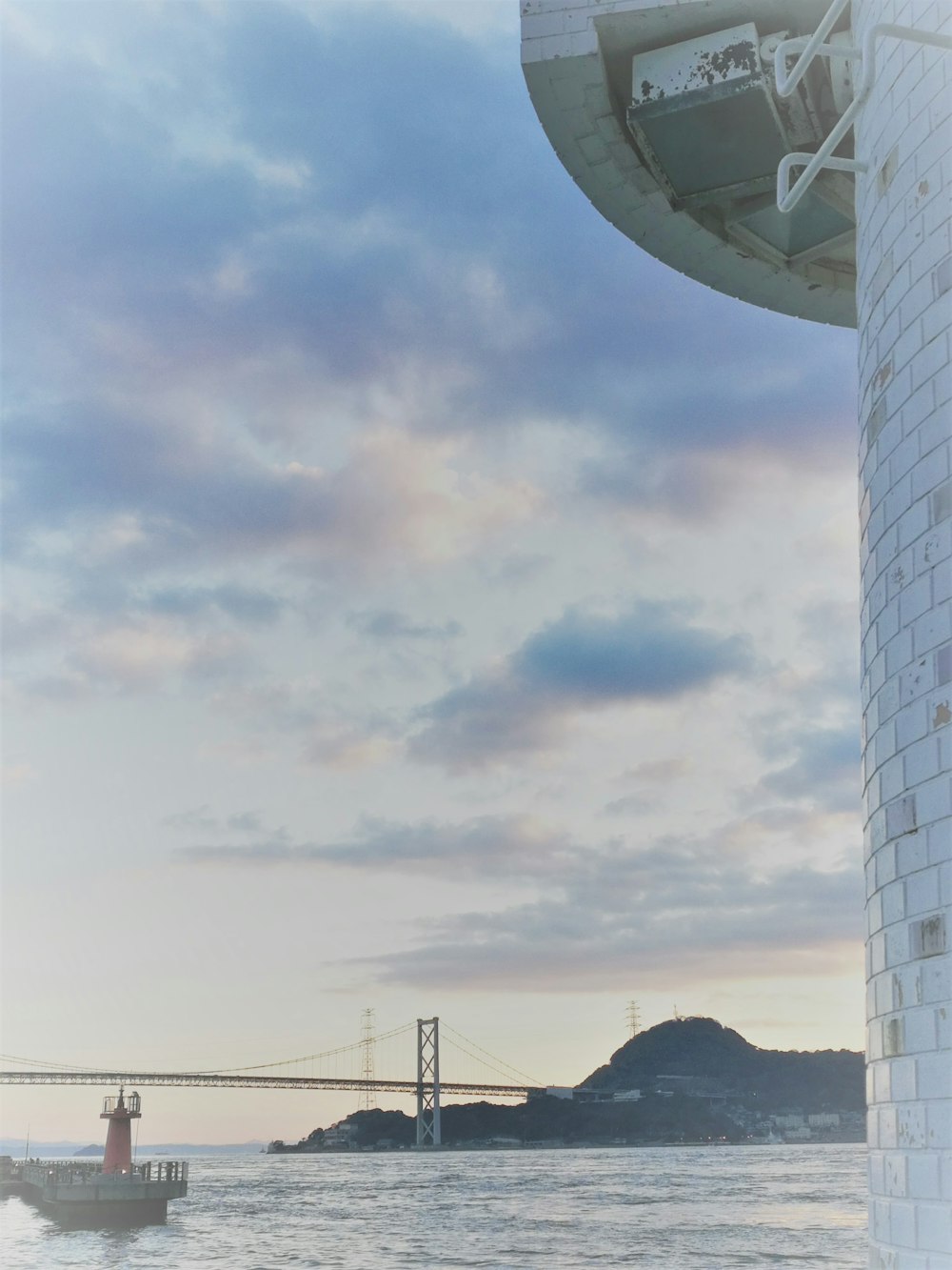 a boat is in the water near a tower