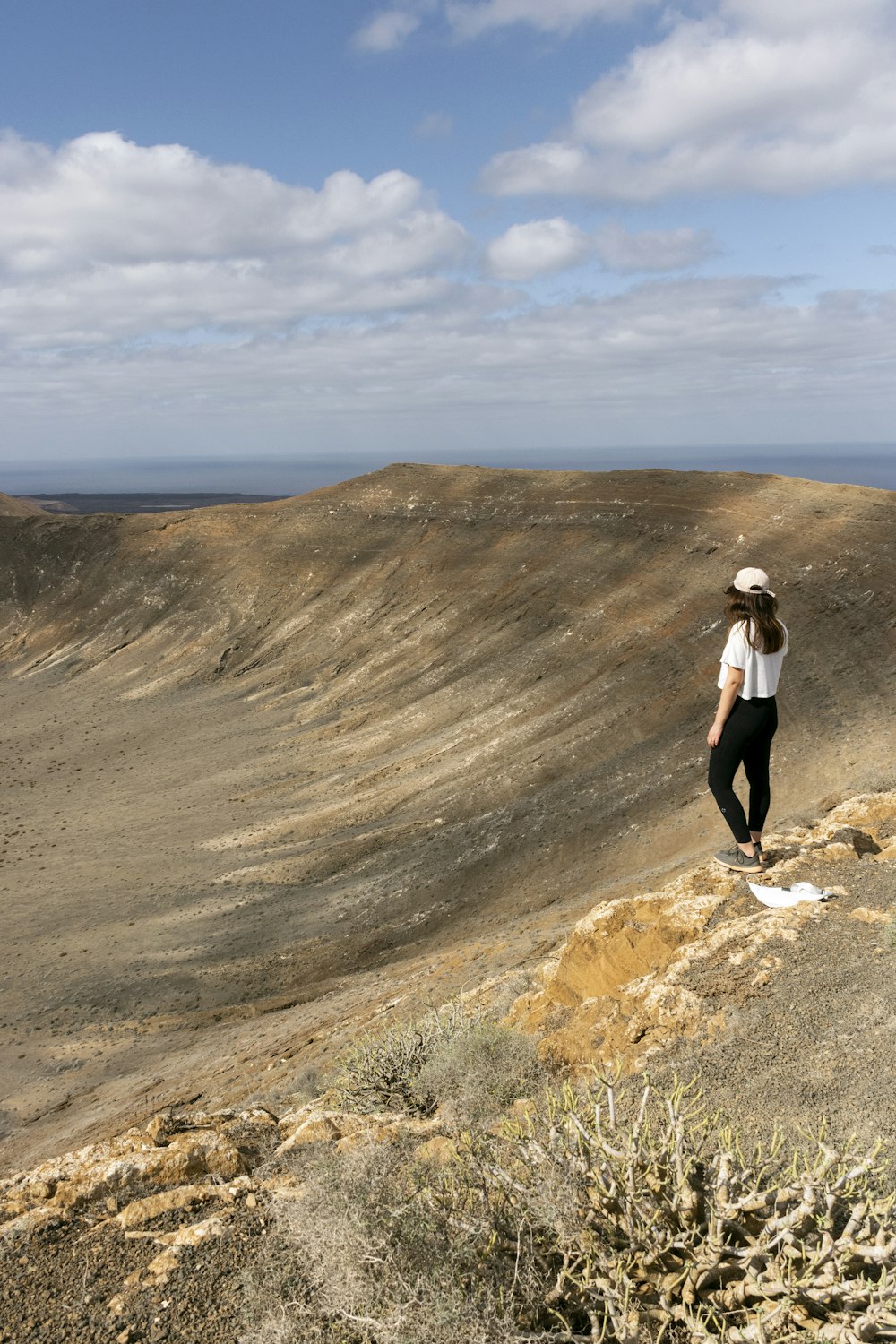 a woman standing on top of a hill