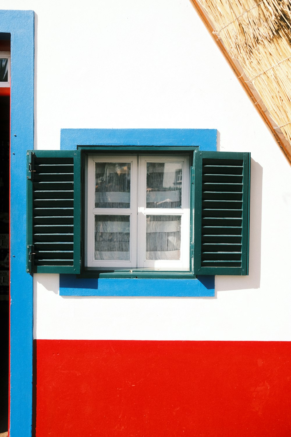 a red, white, and blue building with a window