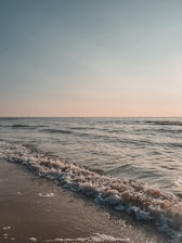 a beach with waves coming in to shore