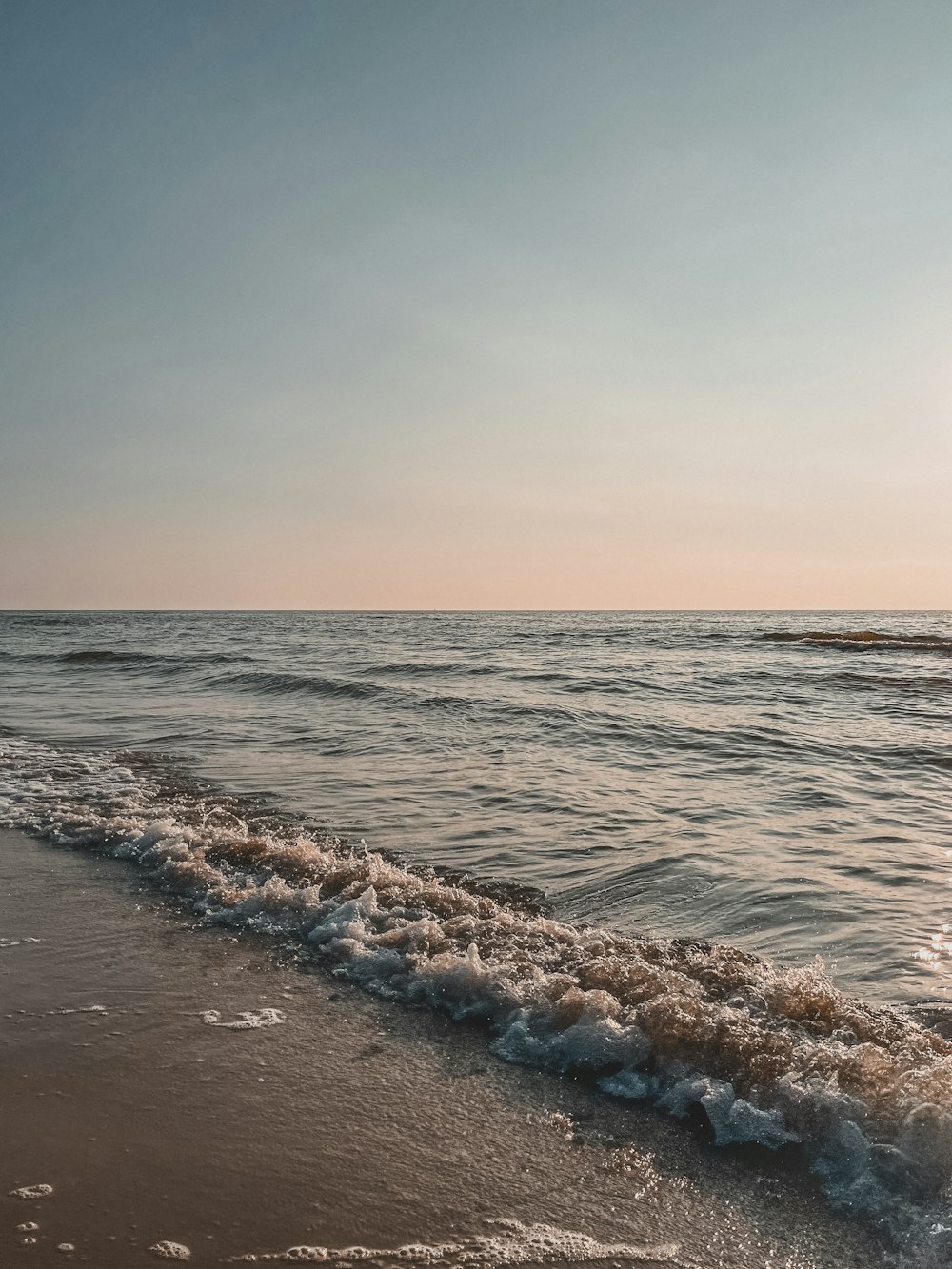 a beach with waves coming in to shore