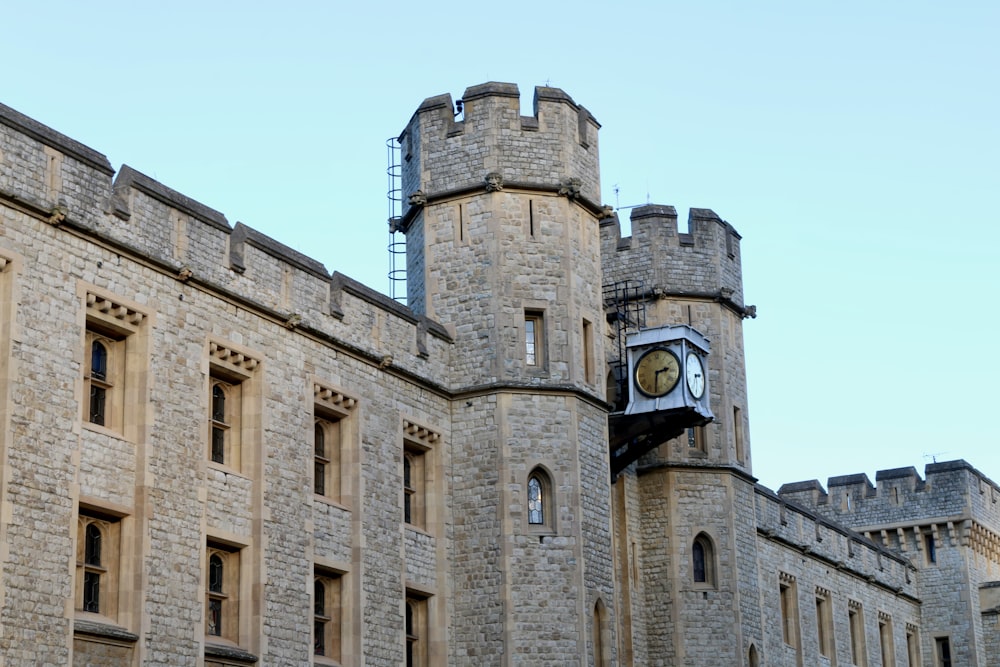 a clock on the side of a stone building