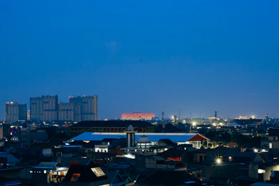 Atlanta skyline visible from a rooftop terrace at twilight.