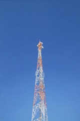 a very tall tower with a clock on it's side