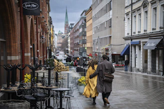 a couple of people walking down a street