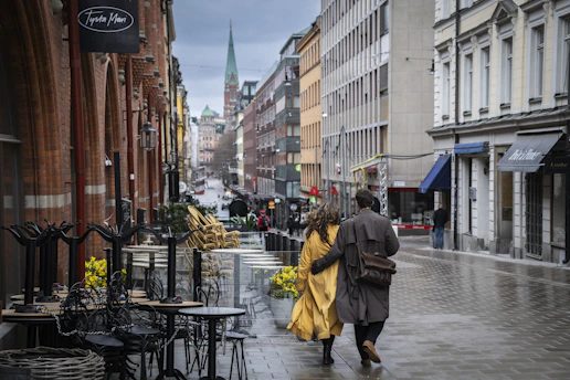 a couple of people walking down a street